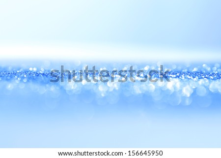 Abstract blue bright sparkles defocused background
