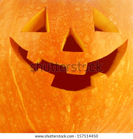 Funny carved Halloween pumpkin background close-up