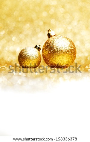 Golden christmas ball on glitter background close-up