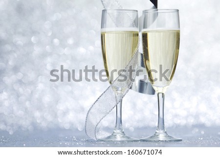 New year card with Champagne on shiny glitter background