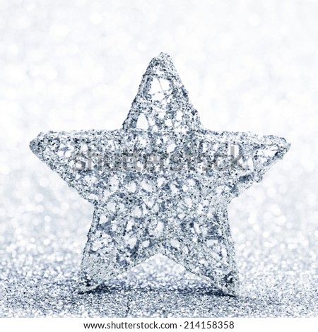 Christmas decorative silver star on shiny glitters background