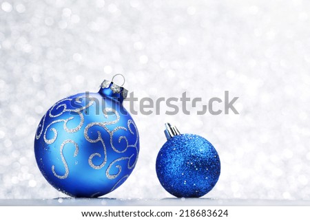 Blue Christmas balls on abstract glitter silver background