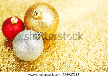 Beautiful christmas balls on abstract glitter background close-up