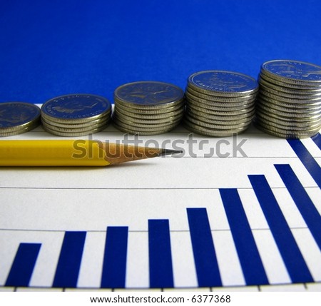 A yellow pencil  pointing to the highest bars on a bar graph in front of four piles of coins with increasing height