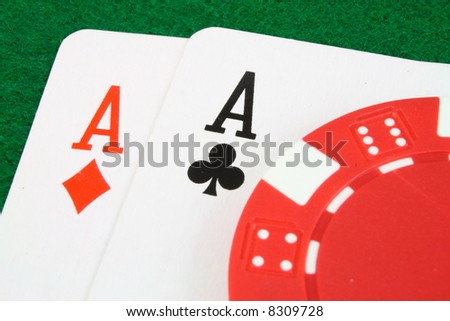 pair of aces and a gambling chip