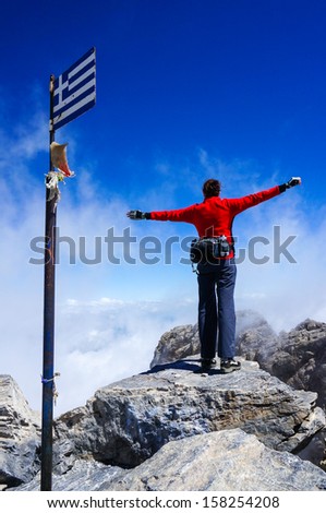 Woman on top of mountain. Greece, Mount Olympus, the summit of Mytikas, highest point of Greece