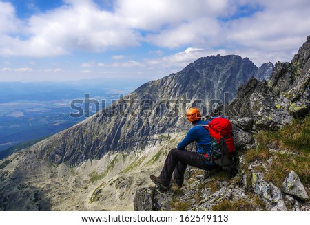 Mountaineer man with helmet enjoying the rocky landscape in the mountains. High Tatra Mountains, Carpathians, Slovakia.