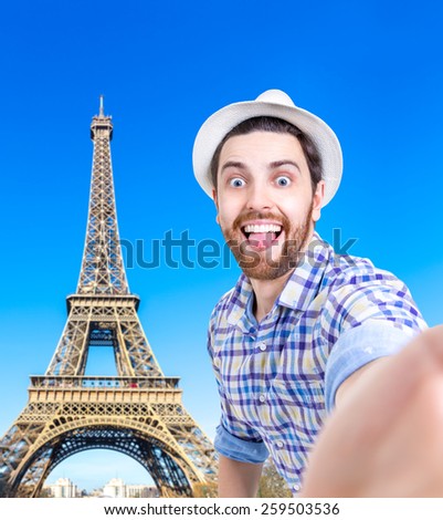 Happy young man taking a selfie photo in Paris, France