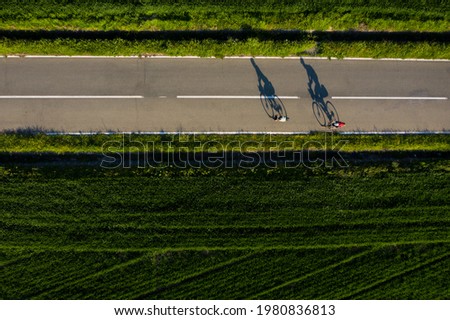 Similar – Image, Stock Photo shadow of cyclist on the side of bridge