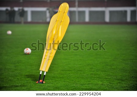 One yellow soccer training dummy on the field