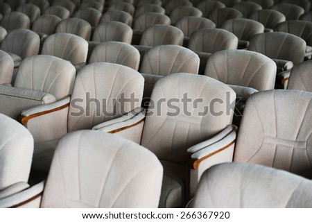 Rows with lots of empty beige velvet armchairs in a big conference room