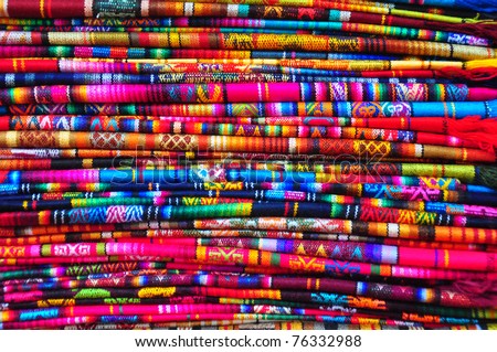 Brightly coloured textiles in craft market, Ecuador