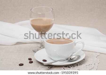 Cup Of Coffee and Irish Cream Liquor. Natural Linen Background.