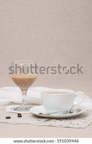 Cup Of Coffee and Irish Cream Liquor. Natural Linen Background.