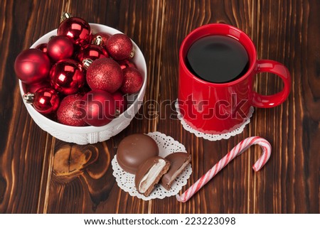 Mug Of Tea Or Coffee. Sweets. Christmas Decorations. Red Balls And Bells. Wooden Background.
