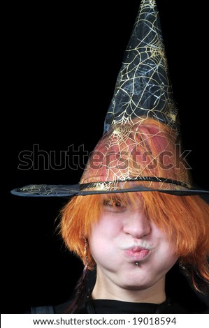 red-hair scarecrow in wizard\'s hat on black background