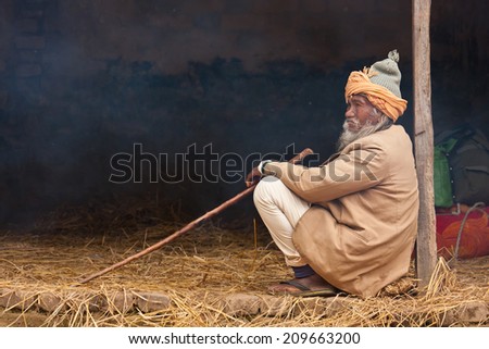 Bardia, Nepal - January 15, 2014: Very old poor taru man sitting in Bardia, Nepal