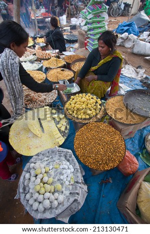 Bardia, Nepal - January 16, 2014: Nepali pastries and sweet street seller during Maggy festival fair in Bardia, Nepal