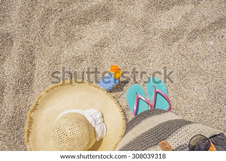 sun care  bottle, sandy beach, sandals, straw hat, for background