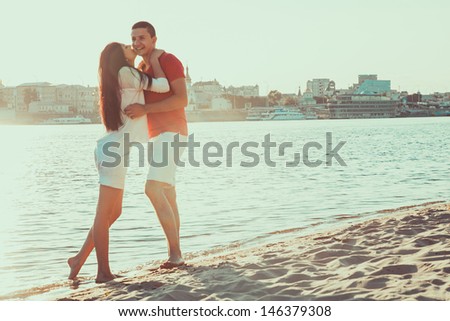 A love story. A man and a woman beautiful couple near the water on the shore of the sea and rivers. Love and kisses.