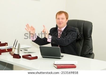 Business man, employee sitting at his desk. Company director, head of department, in the workplace in the business office. Manager, notebook, office, work, desk, documents, work - concept processes.