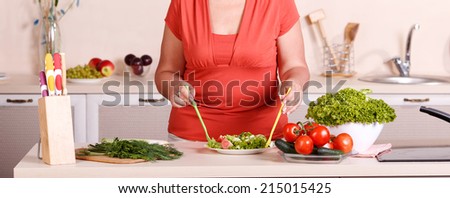 Close up of human hands cooking vegetables salad in kitchen. Adult woman, hands only,  working in the kitchen. Woman prepares a salad. Cooking and food concept. Woman while preparing food in kitchen.