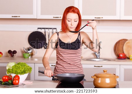 Cook food on the stove. Young girl fries and cooks the food in the pan. Cook healthy food. Electric stove for cooking. Woman housewife sweat lunch, breakfast, dinner. Vegetables for eating, cooking.
