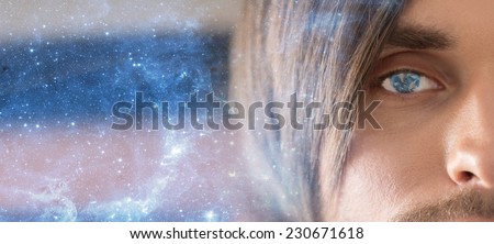 The man face with a reflection of the planet Earth in the pupil of the eye. Space technologies of the future. Male portrait on blue starry sky. The man eyes. Face close up.