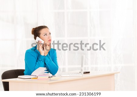 The woman emotionally talking on mobile phone. Telephone calls. She office employee or department head. Talking on the phone with a client about the affairs of the business. Answer the call.