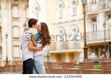 Man, woman, map, city, tourism, holidays - the concept of a modern lifestyle and romantic getaways. Young couple traveling around the city. The love story of the trip. Adventures in a new place.