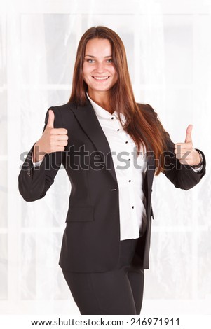 Modern business woman working in bright office. Assistant Manager. Thumbs up. To the top. Very good indication of income and development. Female student. It shows that she likes to go to university.