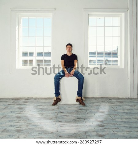 The man in the room. Man as part of the composition, space is smiling. Windows as eyes, this man\'s nose and mouth with a smile painted on the floor. Smile room. Concept for the design and advertising.