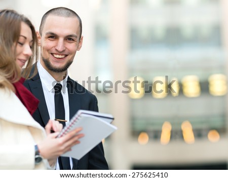 Portrait of a business man in the background of building office center. The plot of a series of business meetings, where the emphasis is on the businessman looks out over a woman. Man of Arab origin.