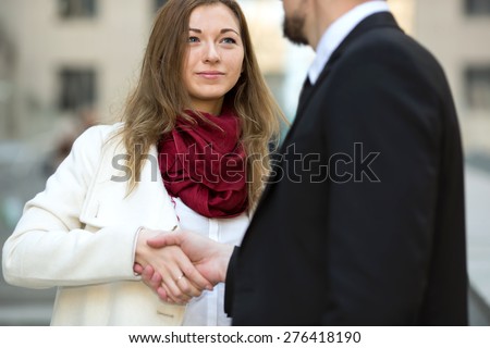 Welcoming business woman giving a handshake. Business contract. Business people. Business meeting. Meet the client. Business communication between man and woman. Business woman the focus of attention.