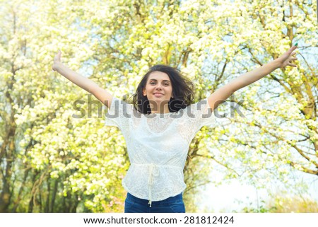Woman on the background of the nature and sunset. Concept - woman, lifestyle, enjoy life, enjoyment, freedom. Happy woman enjoying nature. Beauty girl over sky, nature park and sun light. Story life.