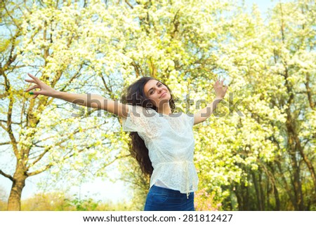 Woman on the background of the nature and sunset. Concept - woman, lifestyle, enjoy life, enjoyment, freedom. Happy woman enjoying nature. Beauty girl over sky, nature park and sun light. Story life.