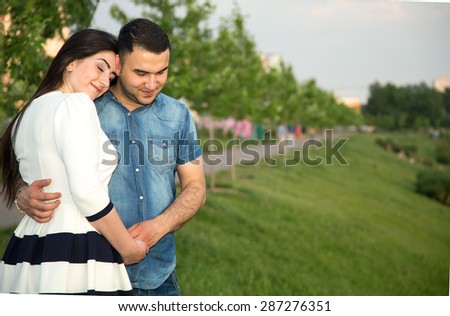 Love Story. Love story man and woman embracing each other. A couple in love. They are looking forward to one another. Young happy family together. They are Arab or Asian origin. Multinational couple.