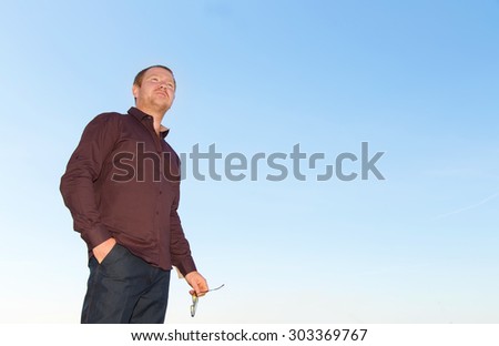 Business people. Red hair man on the blue sky background. Modern business man.