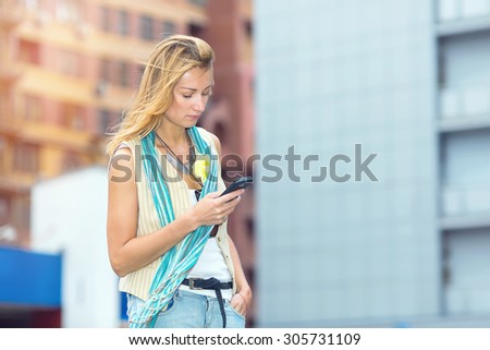 Sad woman reading a text message on your phone. Upset stressed woman holding cellphone. She is read disgusted with message received. Woman face sad, expression emotion feeling.