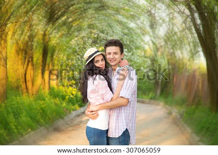 Whirlpool emotions of love. Love at first sight. Couple in love on the background of a green park. Man and woman together - love story. Spring, summer, autumn seasons for amorous adventures.
