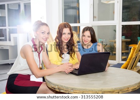 Three woman - students, young women office workers. Meeting, to discuss joint issues. Teamwork on the project. Multinational group of female indoors office or conference room for training. Toned image