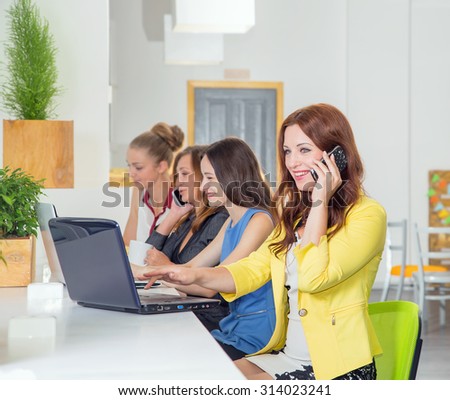 Working days. Group of women. Team. Four young women - office staff. Joint work on the project. Female business in office. Women working at the computer. Toned image. Talk on phone. Telephone calls.