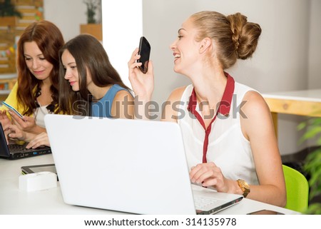 Working days. Women\'s team. Four young women - office staff. Joint work on the project. Woman business. Women working in the office at the computer. Group of women. Group of students. Toned image.