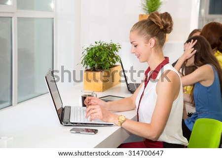 Working without stress. Keep your cool in the workplace. Young woman works at a laptop at work in the office. Business woman, office worker. Girl student doing a university assignment on the computer.