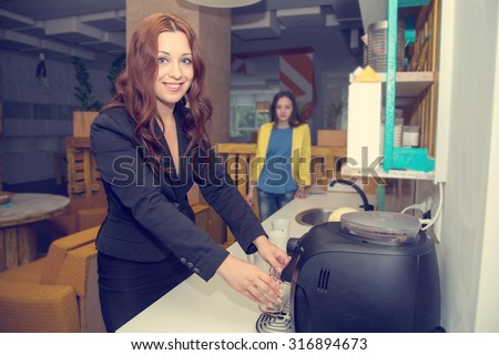 Morning, Woman pouring herself a mug of hot filtered coffee from a coffee machine. Female colleague who is making coffee. Office staff in the morning. Come early in the morning to work. Evening coffee