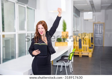 Woman shouts of joy. This is a success! Emotional business woman. Business woman with digital tablet in office. Beautiful woman hold tablet computer on background modern business office.