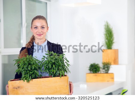 Portrait woman. She is working by profession ecologist. Biologist. She studies the plants, or conduct research. Provide jobs green plants. Green office. Caring for oxygen in an office environment.