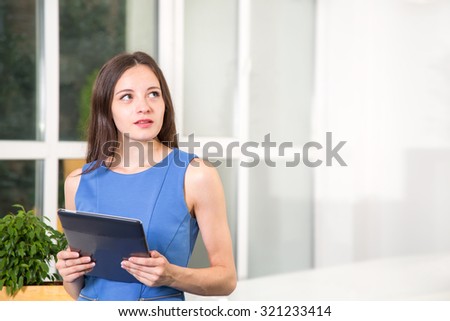 Young woman student using a tablet computer. Woman with tablet pc. Concept - study, education, technology, woman, student with tablet pc computer.