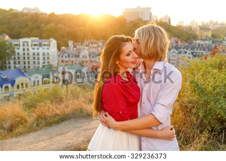Man and woman. Beautiful girl and boy in the sun. Couple in love enjoying tender moments during sunset. Emotional concept of relationship with travel boyfriend and girlfriends relaxing together.