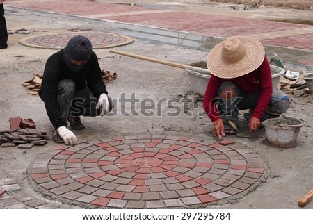 Tiler worker installing floor